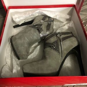 Grey strappy ankle boots.